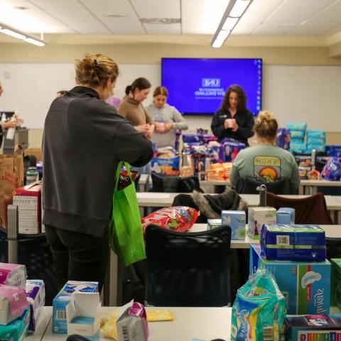 students filling kits full of reproductive health supplies